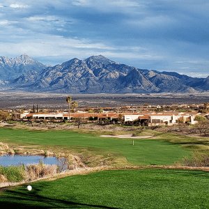 view of golf course with mountains in background